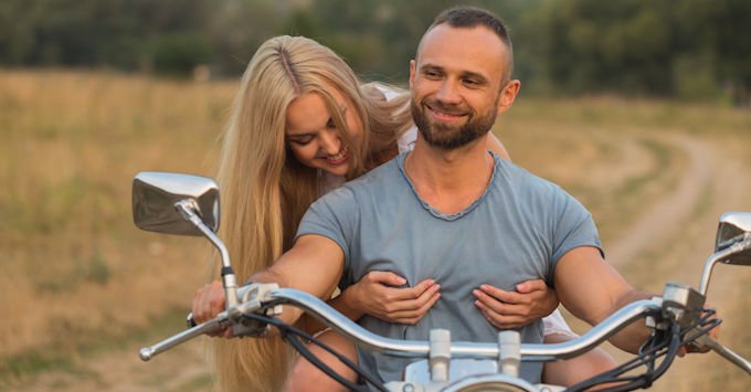Man and woman on a Harley-Davidson motorcycle